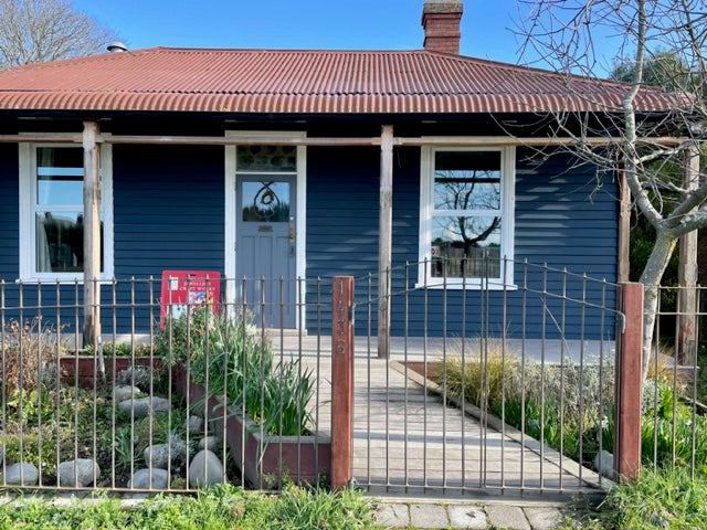 navy blue old cottage front house where the new studio would look like